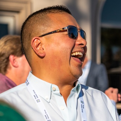 A stylish man wearing sunglasses and a white shirt, embodying the professionalism of Private Advisor Group.