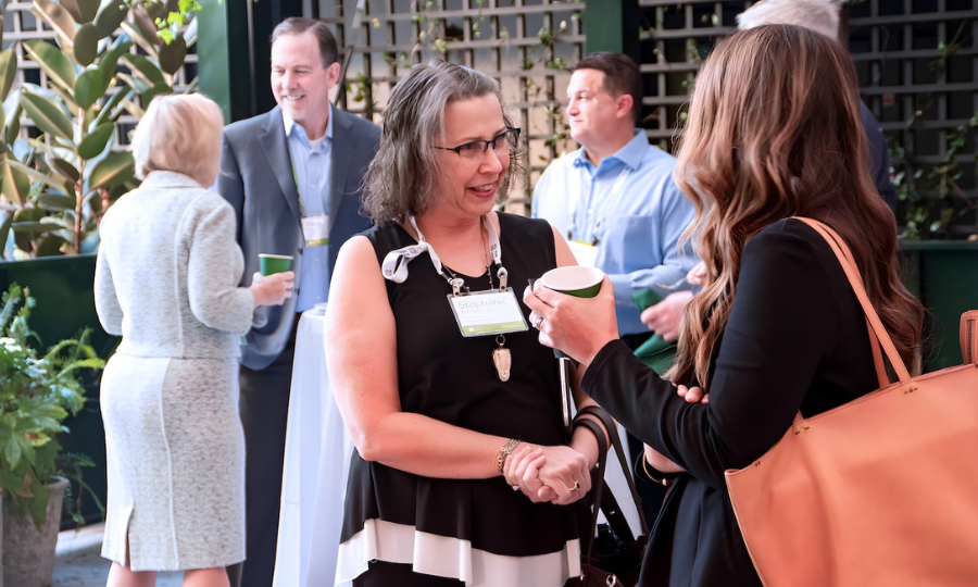 Attendees discussing strategies and ideas at an Advisor Investor Management event, fostering collaboration and connection.