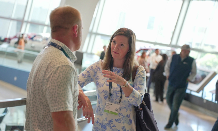 A man and woman engage in a discussion, symbolizing collaboration in investment management.