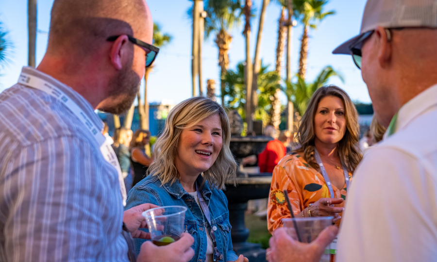 A group of individuals enjoying drinks together at an outdoor event, fostering connections and camaraderie.