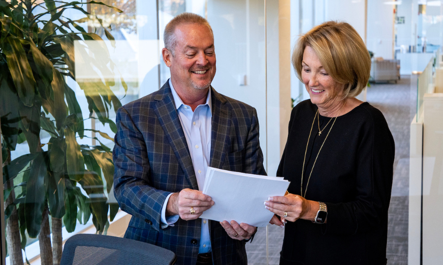 Two professionals in an office reviewing a document, highlighting collaboration and decision-making at Private Advisor Group.