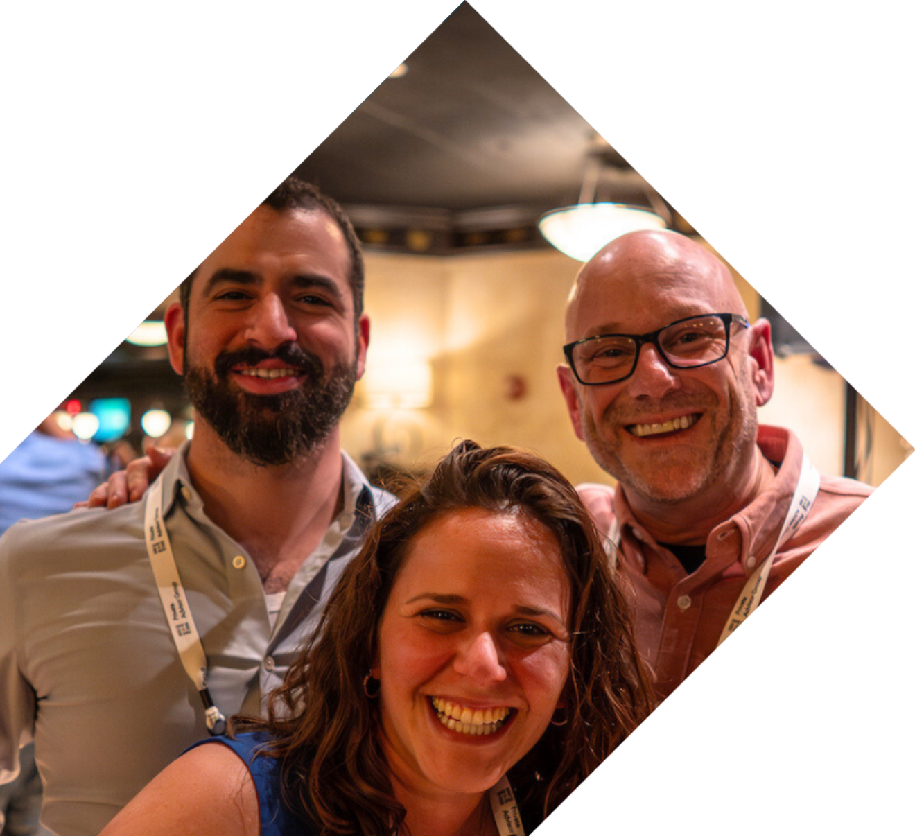 Three smiling individuals in a square frame, representing the supportive community of Your Journey Private Advisor Group.